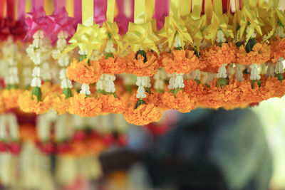 Group of flower garlands in thai style called maalai hanging on the bar in flower shop. garlands 