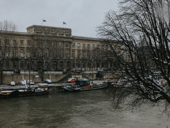 Boats in river with buildings in background