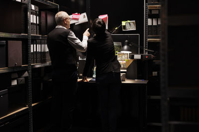 Rear view of woman standing in store