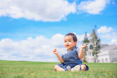 Full length of cute baby girl on field against sky