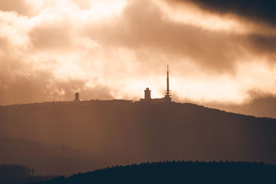 Silhouette of tower against sky during sunset