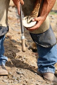 Low section of man working on mud