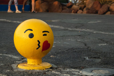 Close-up of smiley face on road