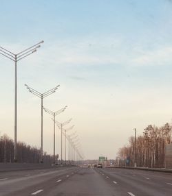 Street by road against sky in city