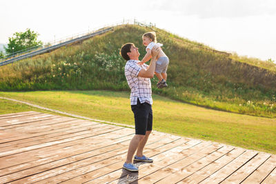 Rear view of couple standing on landscape