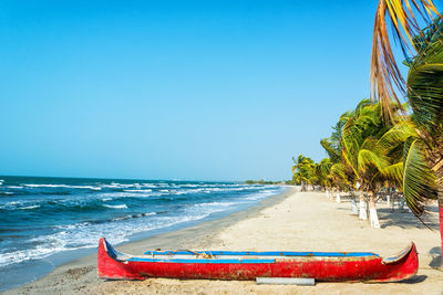 Boat at beach against clear sky