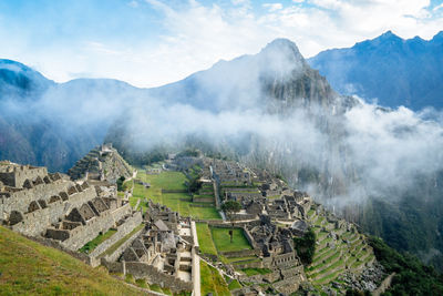 Scenic view of mountains against cloudy sky