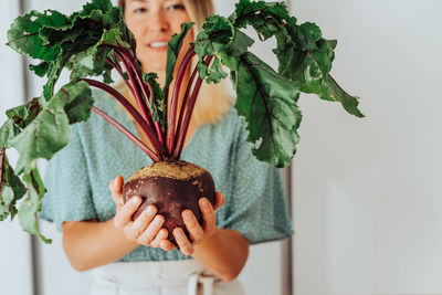 Close-up of woman holding plant