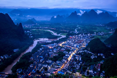 High angle view of buildings in city at night