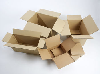 High angle view of empty cardboard boxes over white background