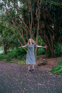 Full length of a girl standing against plants