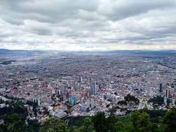 High angle view of city buildings against sky