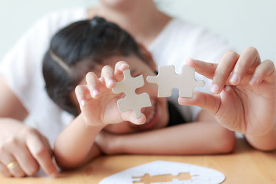 Close-up of baby playing with hands