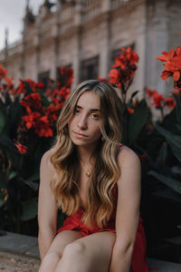 Portrait of beautiful young woman sitting outdoors