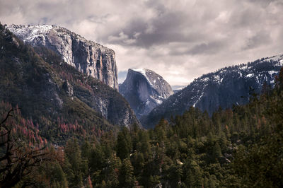 Scenic view of mountains against cloudy sky