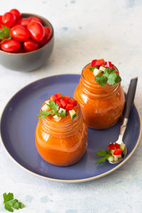 Traditional spanish soup gazpacho with cucumber and tomato garnish. summer cold tomato cream soup.