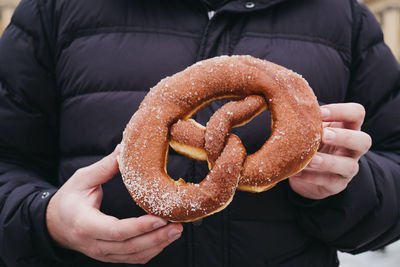 Close-up of hand holding chocolate cake