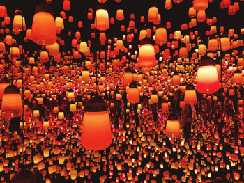 Close-up of illuminated lanterns hanging at night