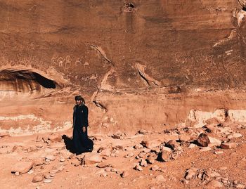 Full length of man standing on rock