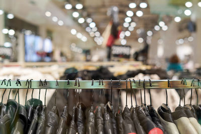 Clothing store inside shopping center, casual clothes, a lot of jackets on hangers