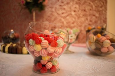 Close-up of candies in glass container on table