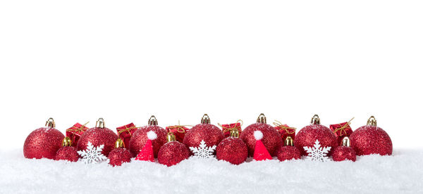 Close-up of christmas decorations over white background