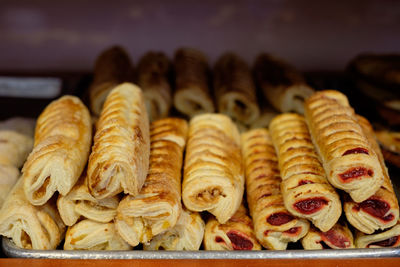 Close-up of baked pastry items for sale in bakery