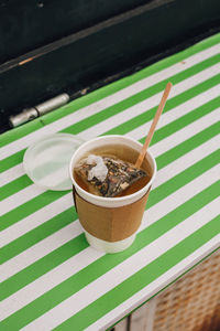 High angle view of hot tea on compostable cup on table. 