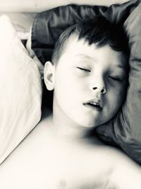 Cute boy sleeping on bed