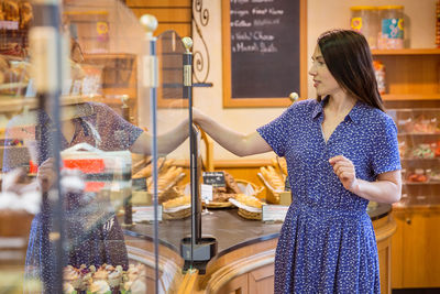 Young pretty woman shopping in a bakery