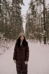 Young woman standing on snow covered land