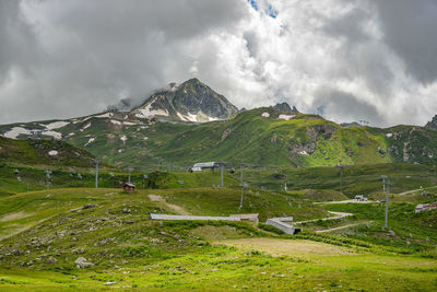 Scenic view of field and mountains against sky