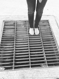 Low section of woman standing on tiled floor