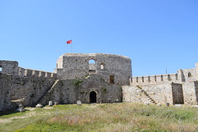 Low angle view of castle against clear blue sky