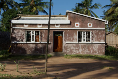 Exterior of house by building against sky