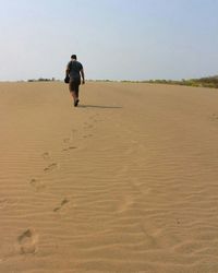 Full length of woman standing on landscape against clear sky