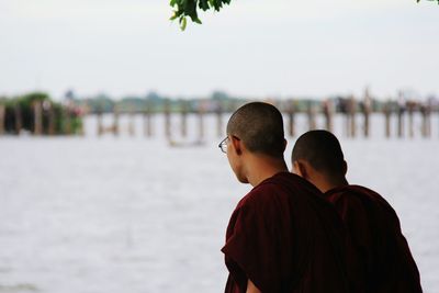 Rear view of monks against sky