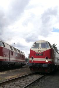 Train at railroad station against sky