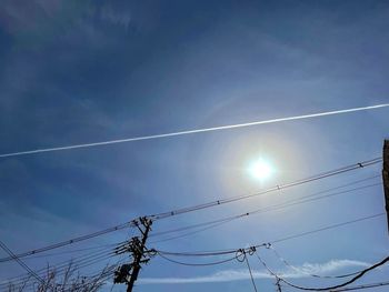 Low angle view of cables against blue sky