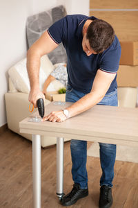 Low section of man working at workshop