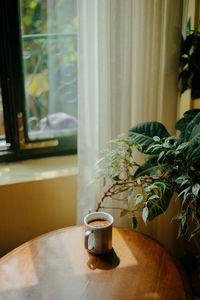 Close-up of flower vase on table at home