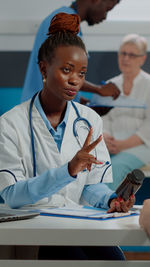 Female doctor examining patient at clinic