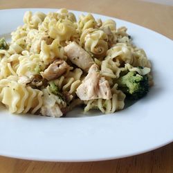 Close-up of chicken meat and vegetable pasta on plate