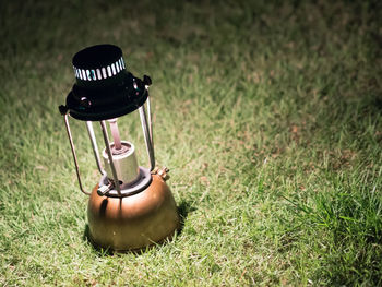 Close-up of electric lamp on field