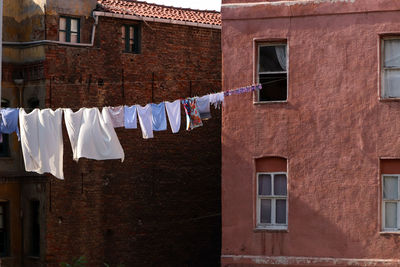 Low angle view of clothes drying outside building