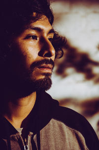 Close-up portrait of young man looking away