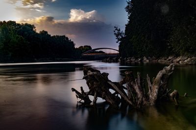 Scenic view of lake by trees against sky