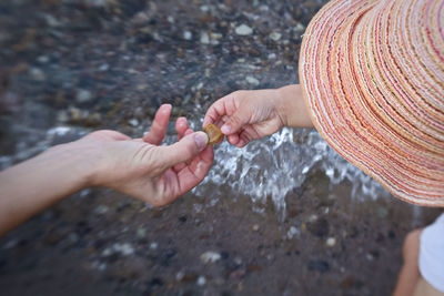 High angle view of people hands in water