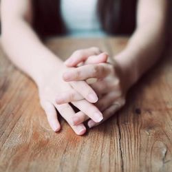 Close-up of woman hand on table