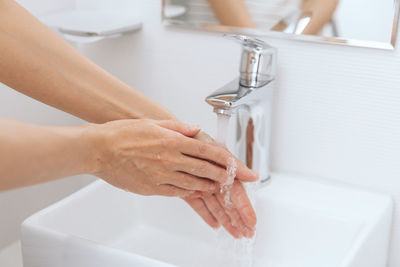 Midsection of woman in bathroom